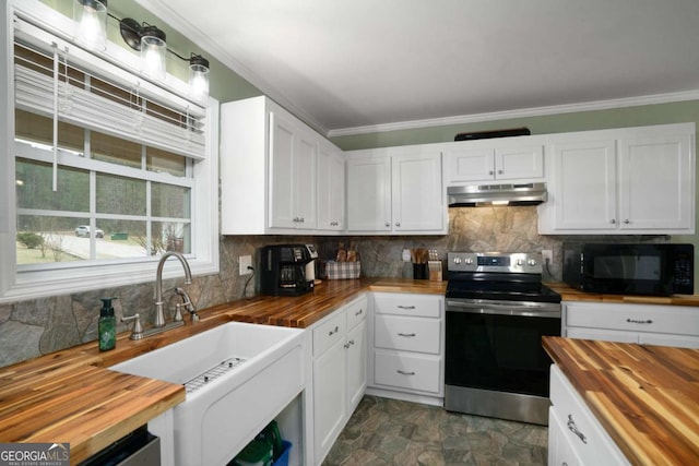 kitchen featuring electric range, under cabinet range hood, black microwave, butcher block counters, and crown molding