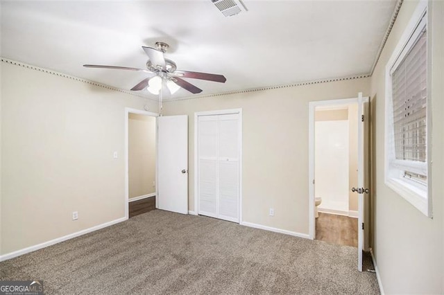 unfurnished bedroom featuring a closet, visible vents, baseboards, and carpet