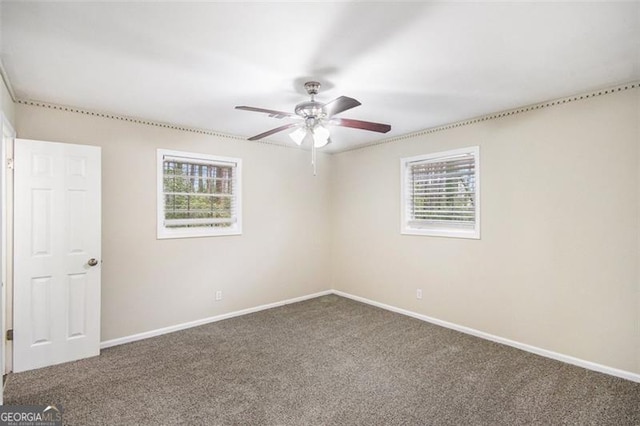 spare room featuring carpet flooring, ceiling fan, and baseboards