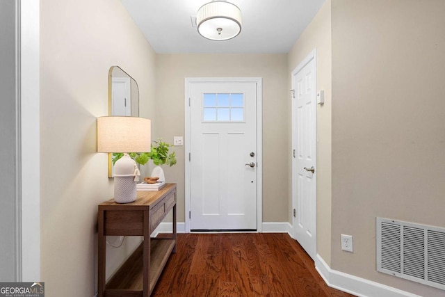 entryway featuring visible vents, baseboards, and wood finished floors