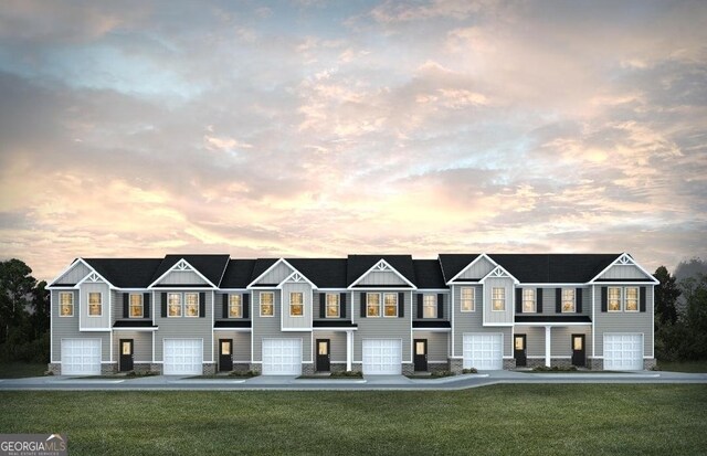 view of front of house with brick siding, board and batten siding, fence, concrete driveway, and an attached garage