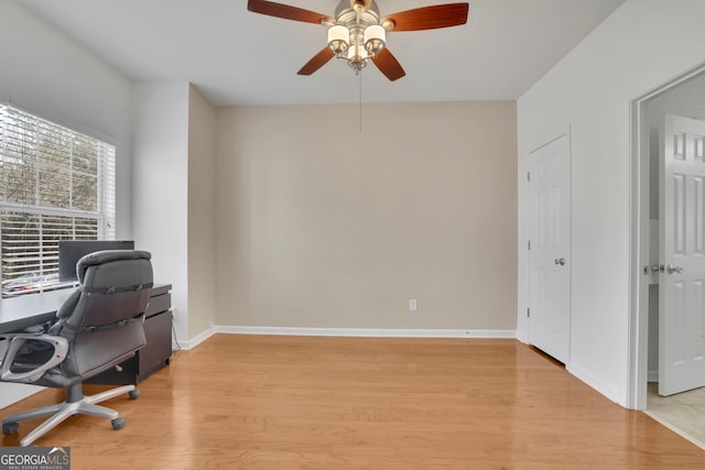 home office with ceiling fan, baseboards, and light wood-style flooring