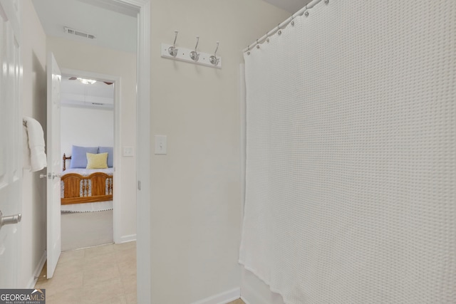 interior space featuring tile patterned floors, visible vents, and baseboards