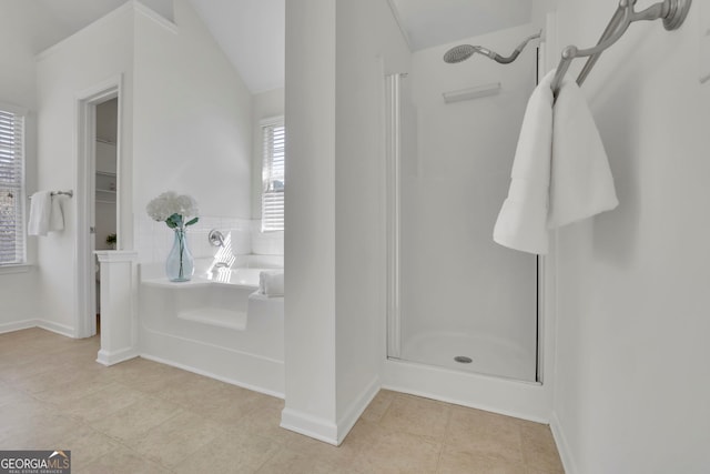 bathroom with tile patterned floors, a bath, and a stall shower