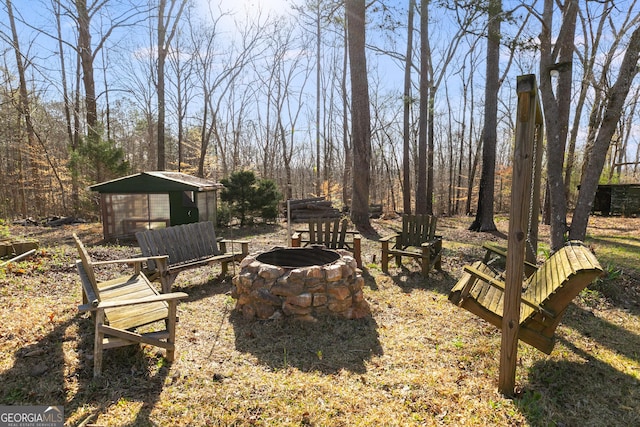 4864 Yeagar Rd, Douglasville, GA 30135 - view of yard featuring an outdoor fire pit, a storage shed, and an outdoor structure