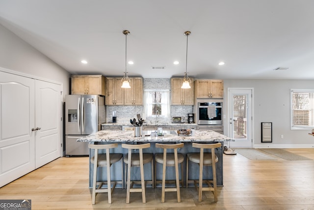 4864 Yeagar Rd, Douglasville, GA 30135 - kitchen featuring tasteful backsplash, visible vents, a center island, and stainless steel appliances