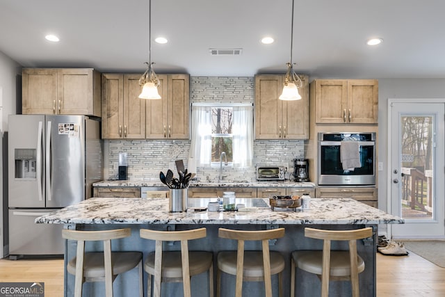 4864 Yeagar Rd, Douglasville, GA 30135 - kitchen featuring a kitchen breakfast bar, backsplash, visible vents, stainless steel appliances, and a sink