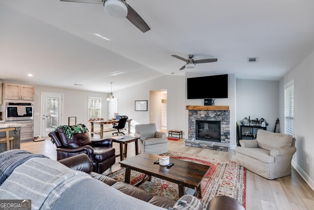 4864 Yeagar Rd, Douglasville, GA 30135 - living room with lofted ceiling, visible vents, a ceiling fan, and light wood-style flooring