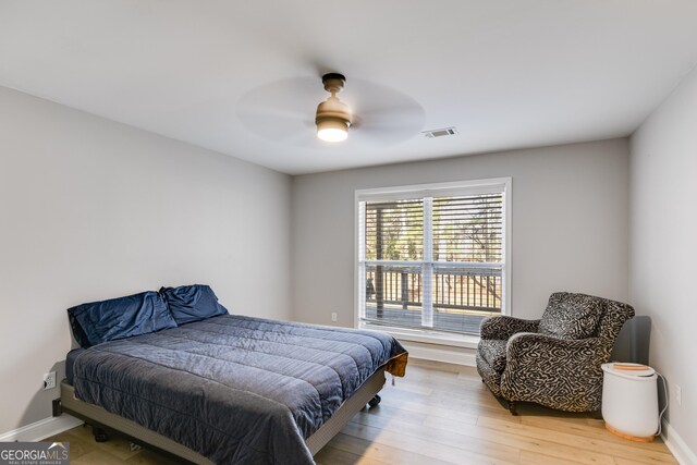 4864 Yeagar Rd, Douglasville, GA 30135 - bedroom with light wood finished floors, baseboards, a ceiling fan, and visible vents