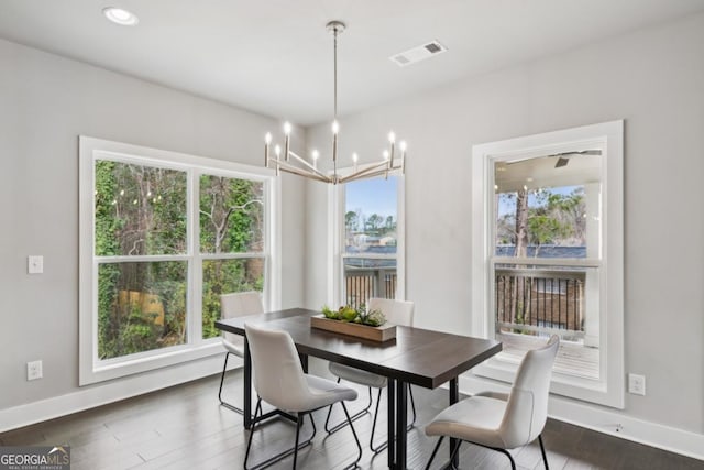 dining area with a chandelier, visible vents, baseboards, and a wealth of natural light