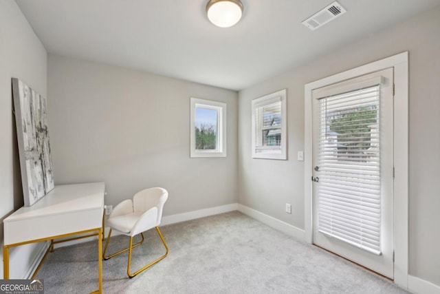 sitting room with baseboards, visible vents, and carpet floors