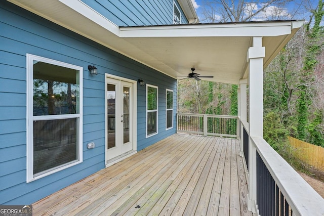 wooden terrace featuring french doors, a ceiling fan, and fence