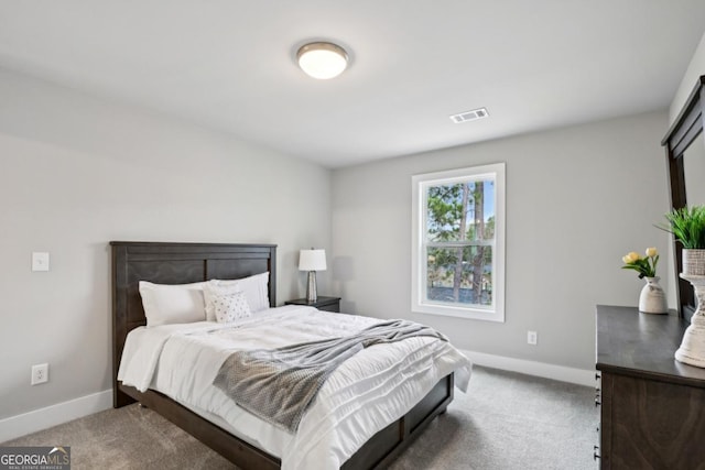 carpeted bedroom featuring baseboards and visible vents