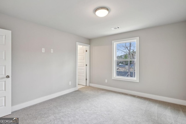 unfurnished bedroom with carpet flooring, baseboards, and visible vents