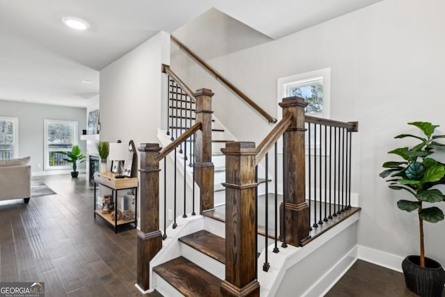 stairway featuring recessed lighting, baseboards, and wood finished floors