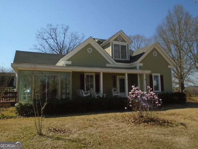 view of front of property with covered porch and a front lawn