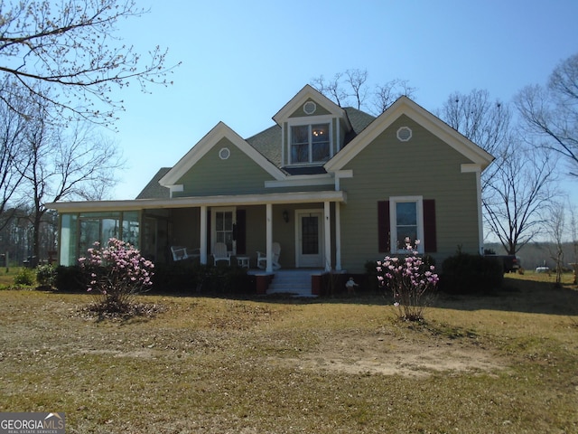 view of front of property featuring a porch and a sunroom