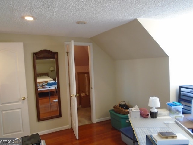 office space with baseboards, lofted ceiling, a textured ceiling, and dark wood-style floors