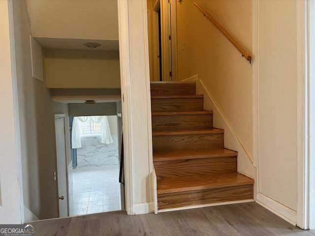 stairway with wood finished floors