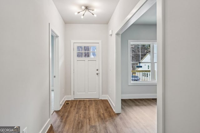 entrance foyer featuring baseboards and wood finished floors