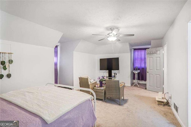 carpeted bedroom featuring visible vents, baseboards, a textured ceiling, and ceiling fan