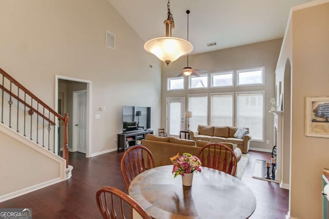 dining area featuring stairs, wood finished floors, visible vents, and baseboards