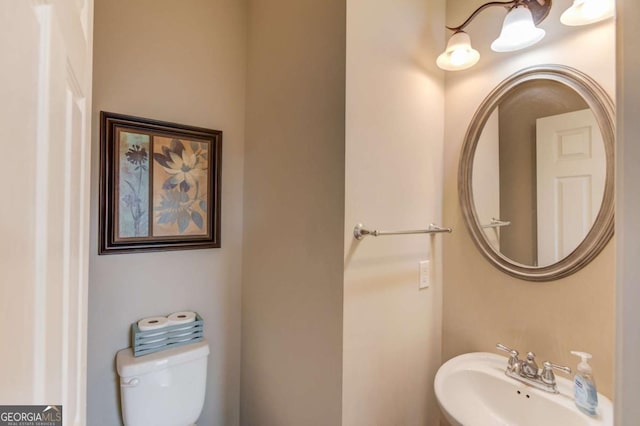 half bath featuring a sink and toilet