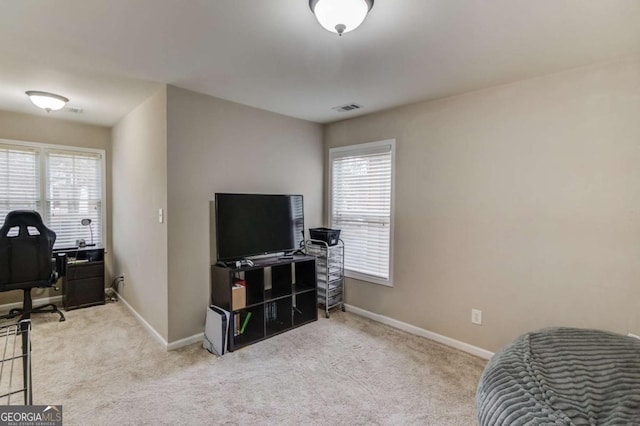 interior space featuring carpet flooring, a healthy amount of sunlight, visible vents, and baseboards