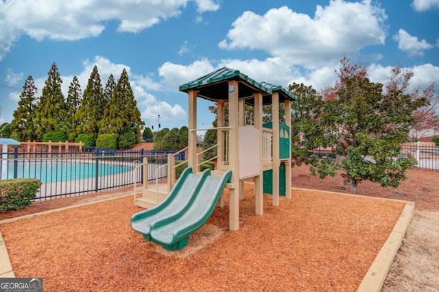 communal playground with a community pool and fence