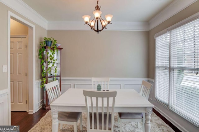 dining room featuring a wainscoted wall, dark wood-type flooring, and ornamental molding