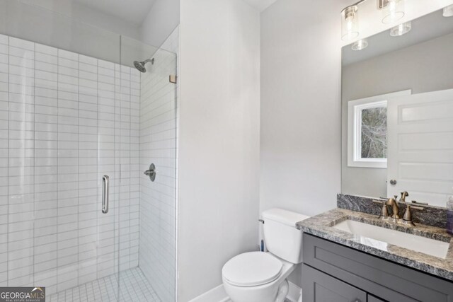 3143 Stonegate Dr SW, Atlanta, GA 30331 - full bathroom with toilet, vanity, baseboards, and a shower stall