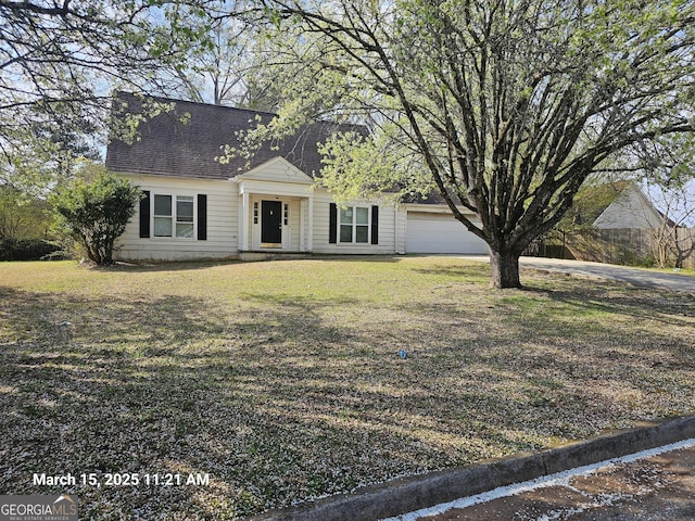 11187 Shannon Cir, Hampton, GA 30228 - cape cod house featuring a front lawn, a garage, and roof with shingles
