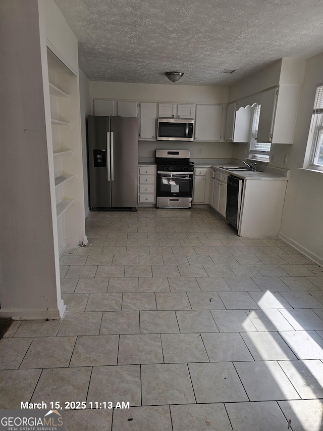 11187 Shannon Cir, Hampton, GA 30228 - kitchen featuring a textured ceiling, stainless steel appliances, light countertops, and a sink