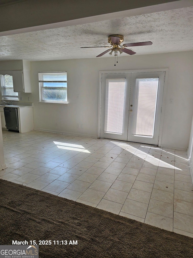 11187 Shannon Cir, Hampton, GA 30228 - interior space featuring a ceiling fan, a textured ceiling, french doors, light tile patterned floors, and baseboards