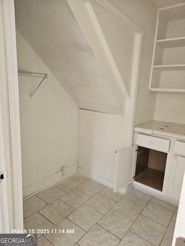 11187 Shannon Cir, Hampton, GA 30228 - additional living space featuring light tile patterned flooring, a textured ceiling, and lofted ceiling