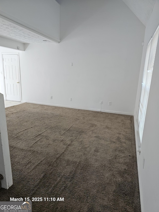 11187 Shannon Cir, Hampton, GA 30228 - carpeted empty room featuring baseboards and high vaulted ceiling