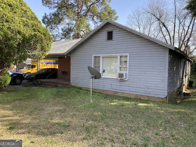 view of side of property featuring a yard and brick siding