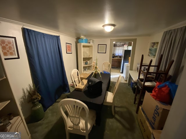 carpeted dining space featuring ornamental molding