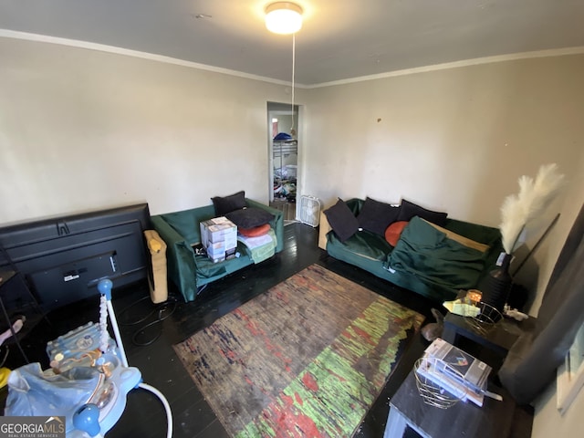 living area featuring crown molding and wood finished floors