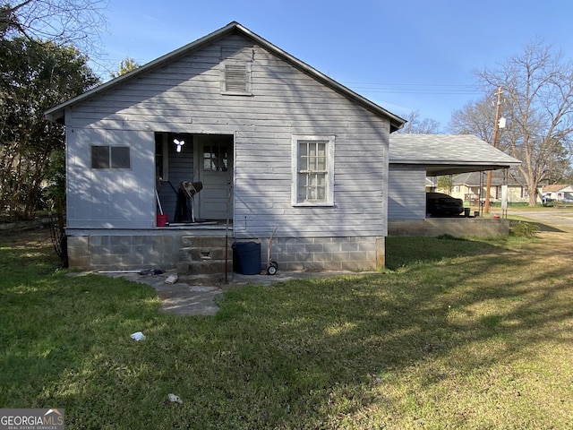 rear view of property featuring a yard