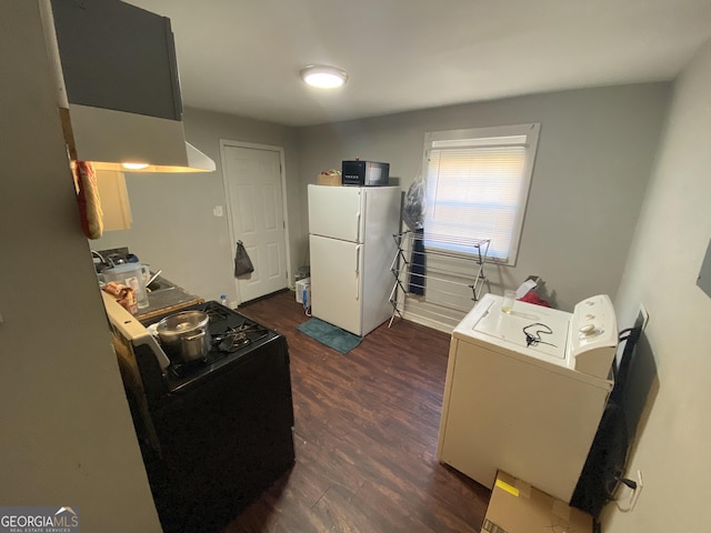 kitchen featuring washer / clothes dryer, black appliances, and dark wood-type flooring