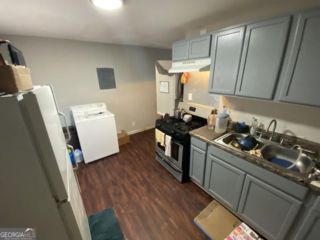 kitchen featuring under cabinet range hood, a sink, washer / clothes dryer, freestanding refrigerator, and stainless steel range with gas cooktop