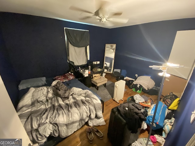 bedroom with a ceiling fan and wood finished floors