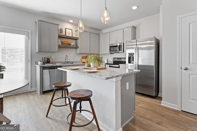 227 Ivey Ter Unit 36, Temple, GA 30179 - kitchen featuring stainless steel appliances, gray cabinets, open shelves, a kitchen breakfast bar, and a center island