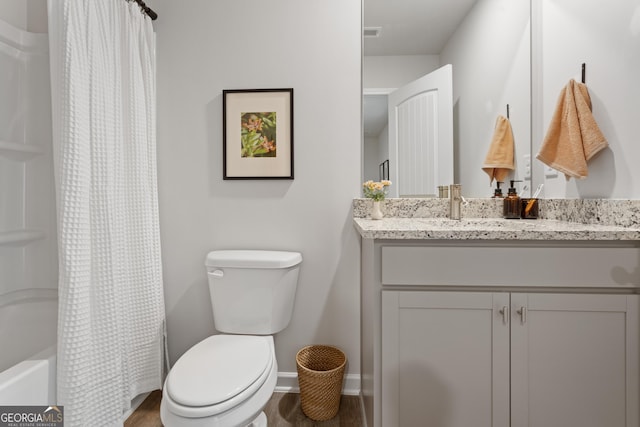 227 Ivey Ter Unit 36, Temple, GA 30179 - bathroom featuring vanity, baseboards, toilet, shower / bath combo, and wood finished floors