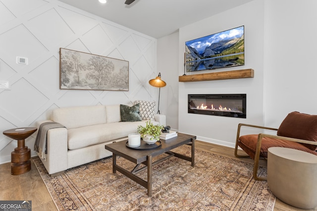 227 Ivey Ter Unit 36, Temple, GA 30179 - living room featuring wood finished floors, a glass covered fireplace, baseboards, and a decorative wall
