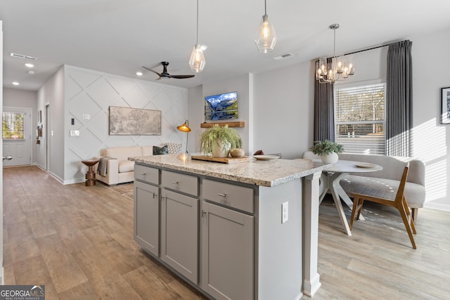 227 Ivey Ter Unit 36, Temple, GA 30179 - kitchen featuring gray cabinets, light wood-type flooring, a chandelier, plenty of natural light, and recessed lighting