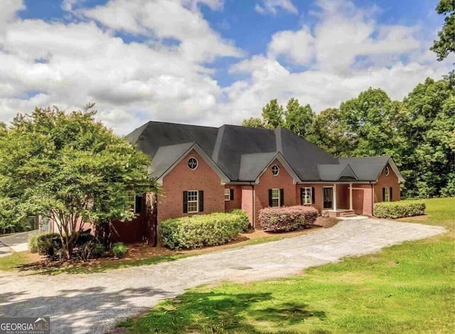 view of front of house with brick siding and driveway