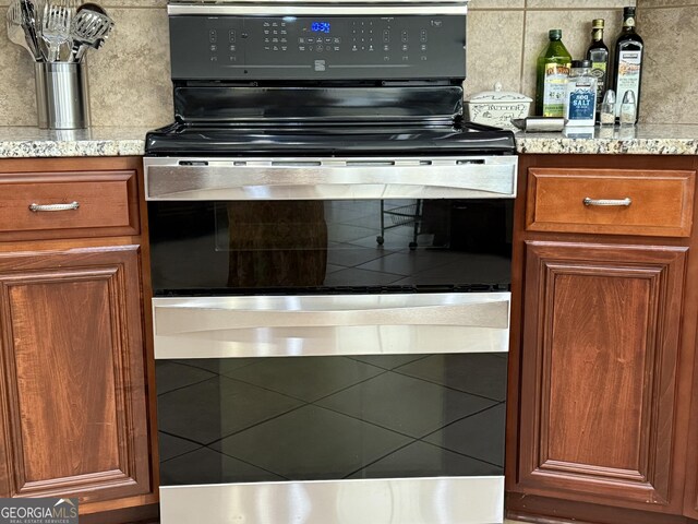 1771 Leon Ellis Rd, Hull, GA 30646 - kitchen featuring brown cabinetry, electric stove, and light stone countertops