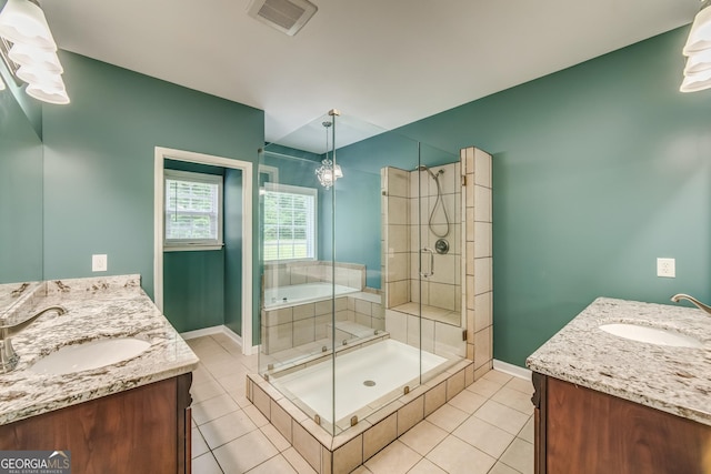 bathroom with a shower stall, tile patterned flooring, visible vents, vanity, and baseboards